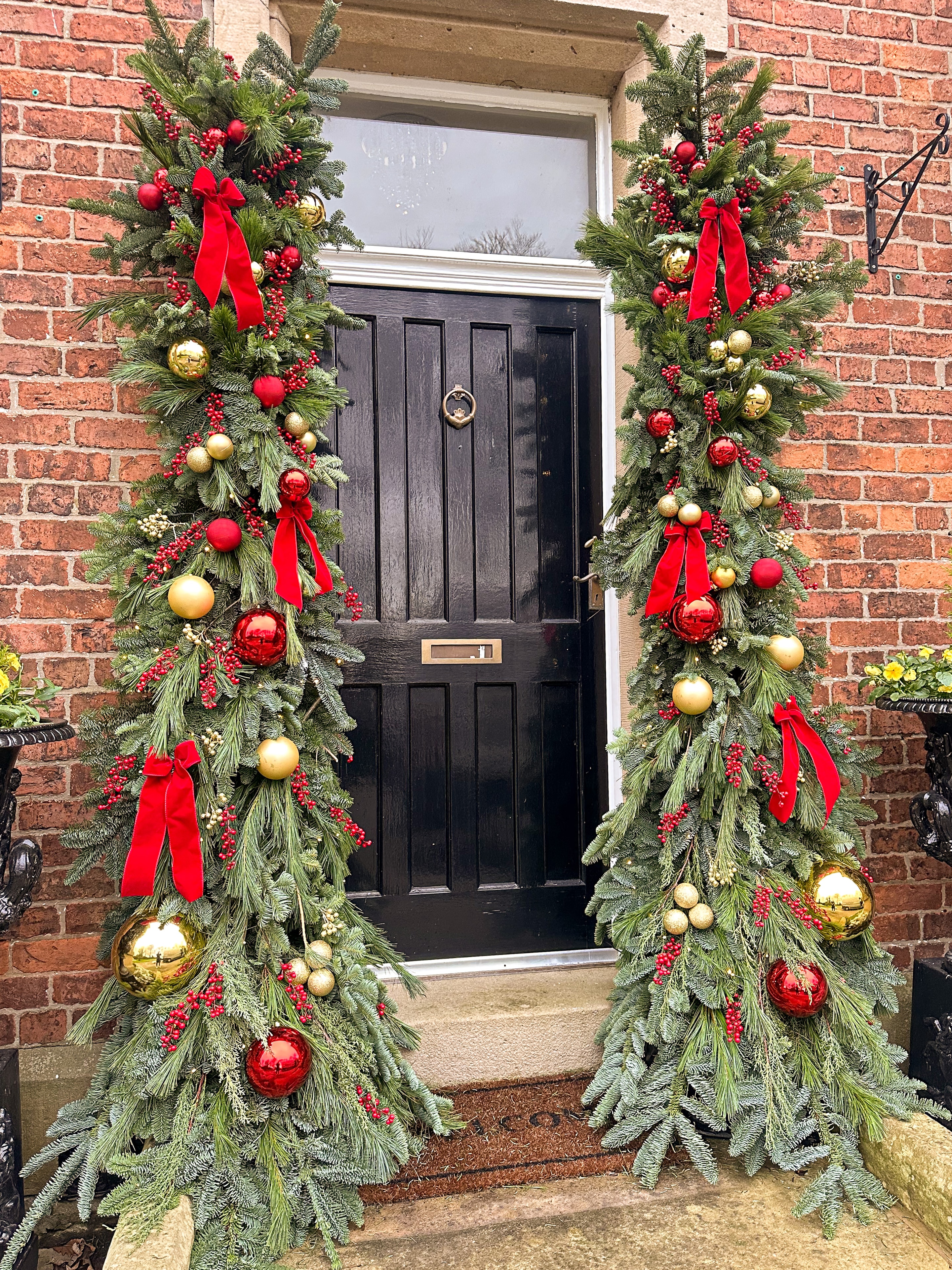 Door pillar garlands with red and gold baubles