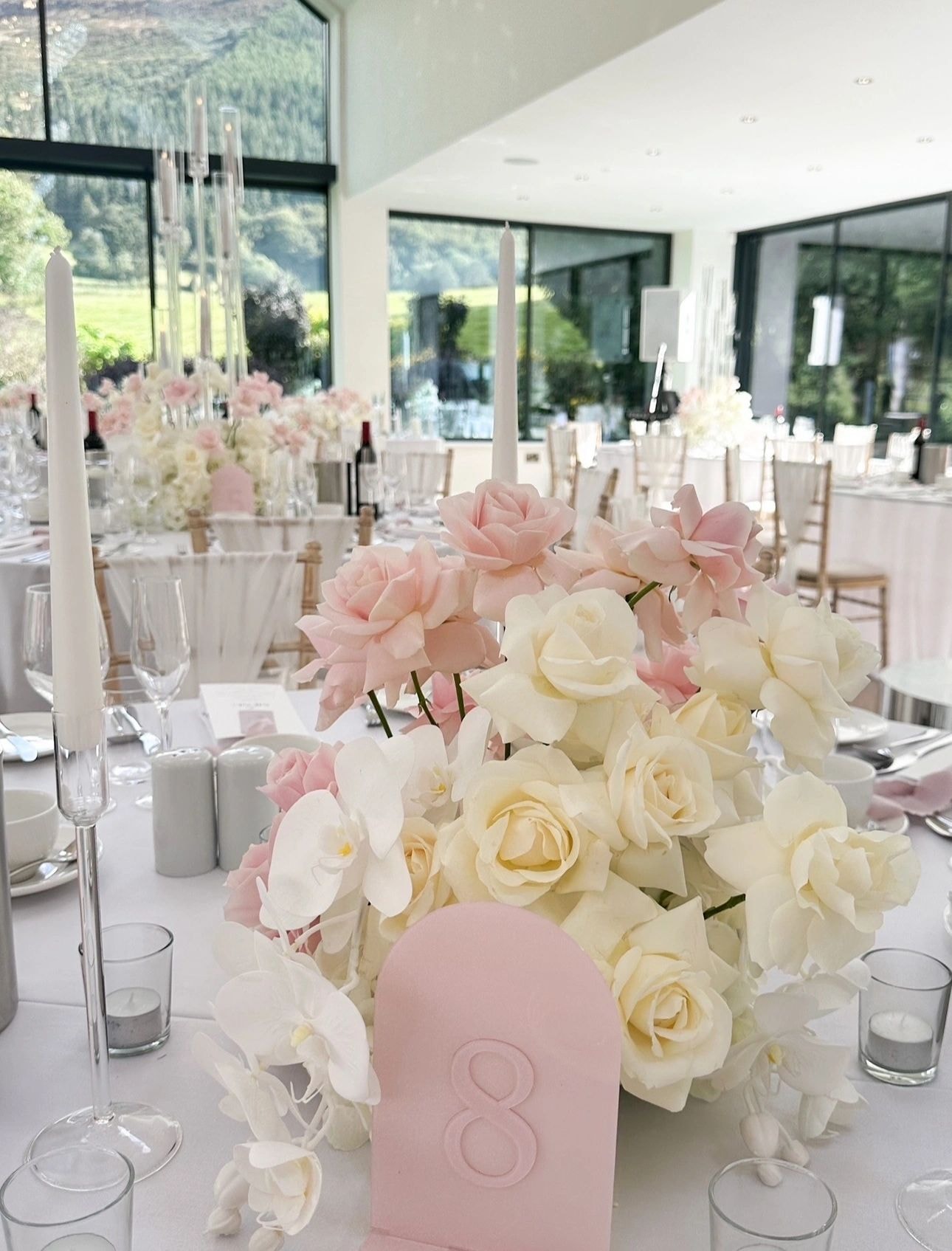 Blush pink and white rose centrepieces with mountain view