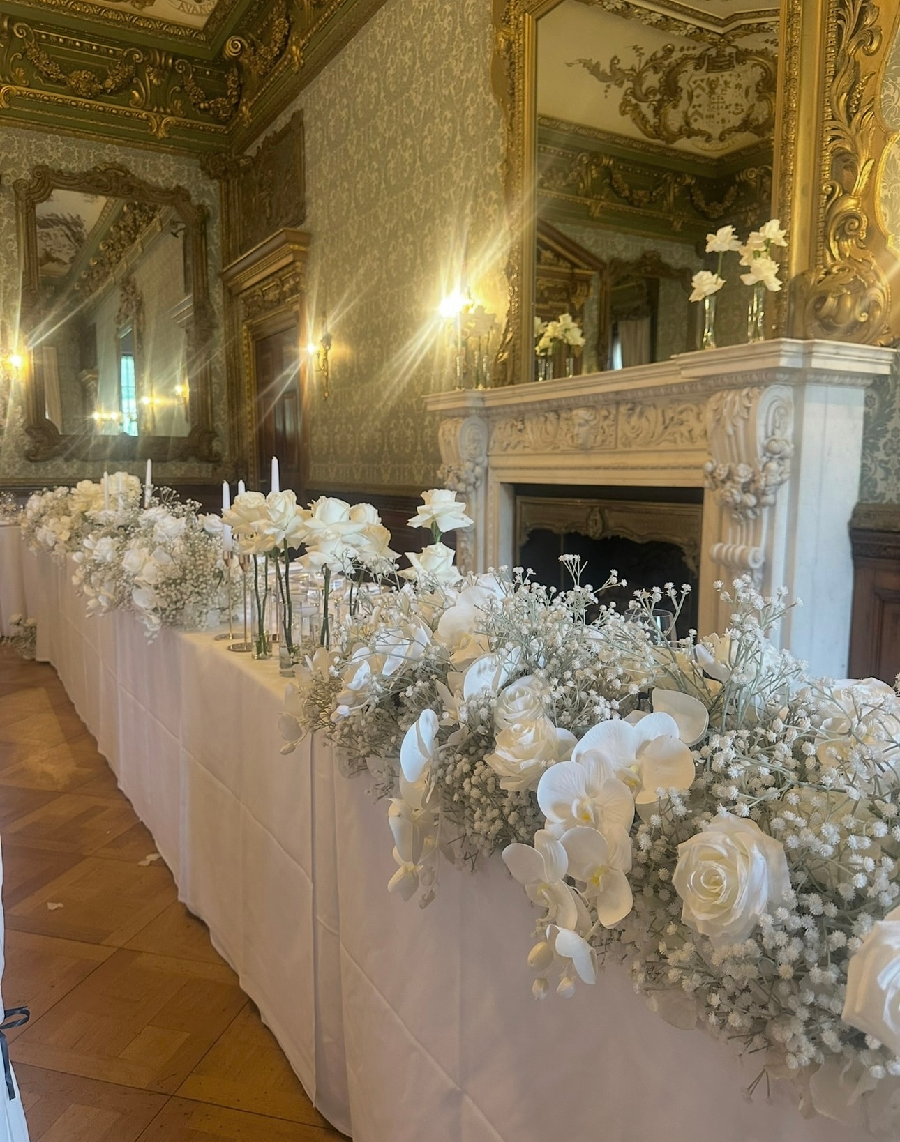 Ballroom top table with white orchid roses and gypsophila cascade
