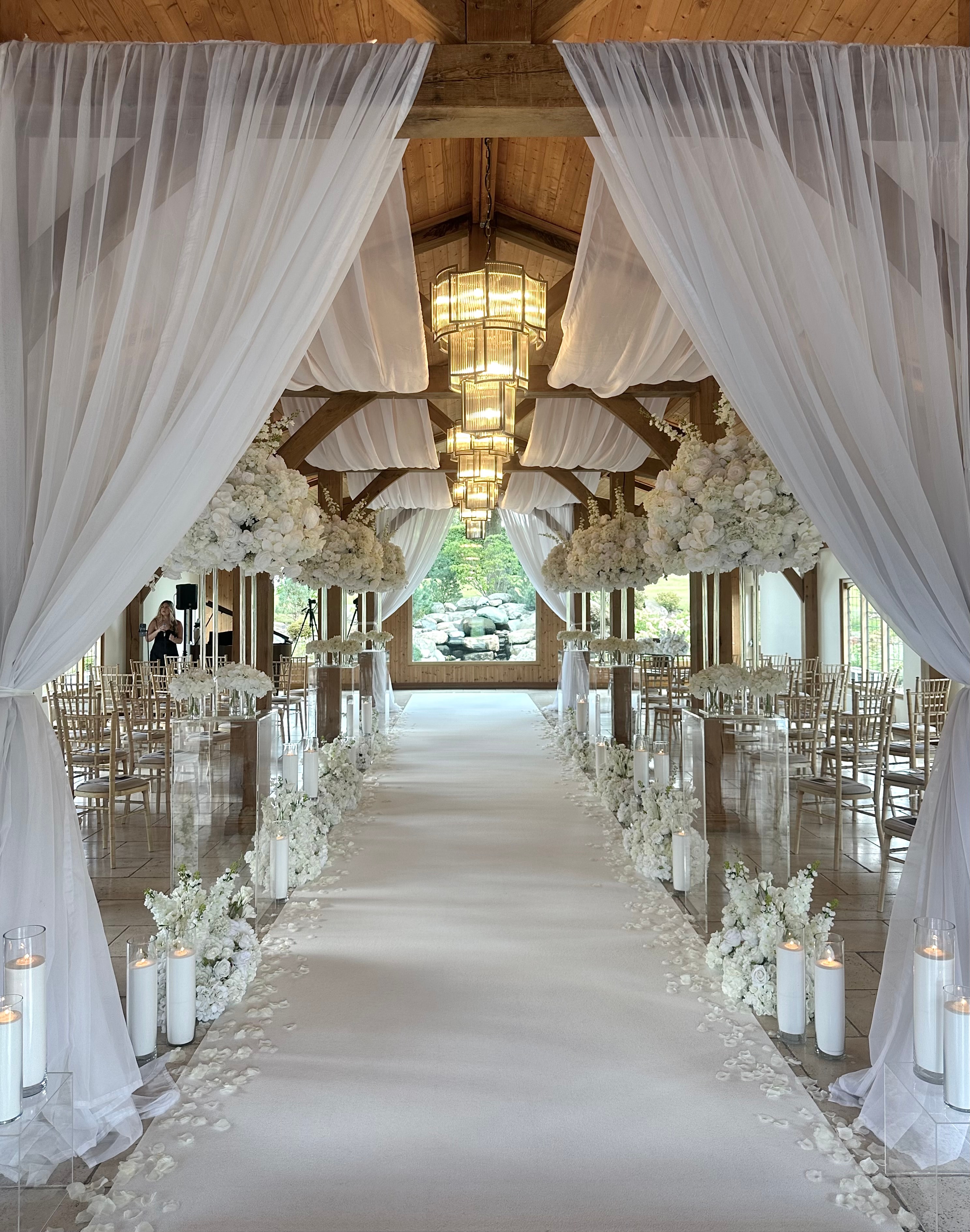 Stunning wedding ceremony aisle with white draping