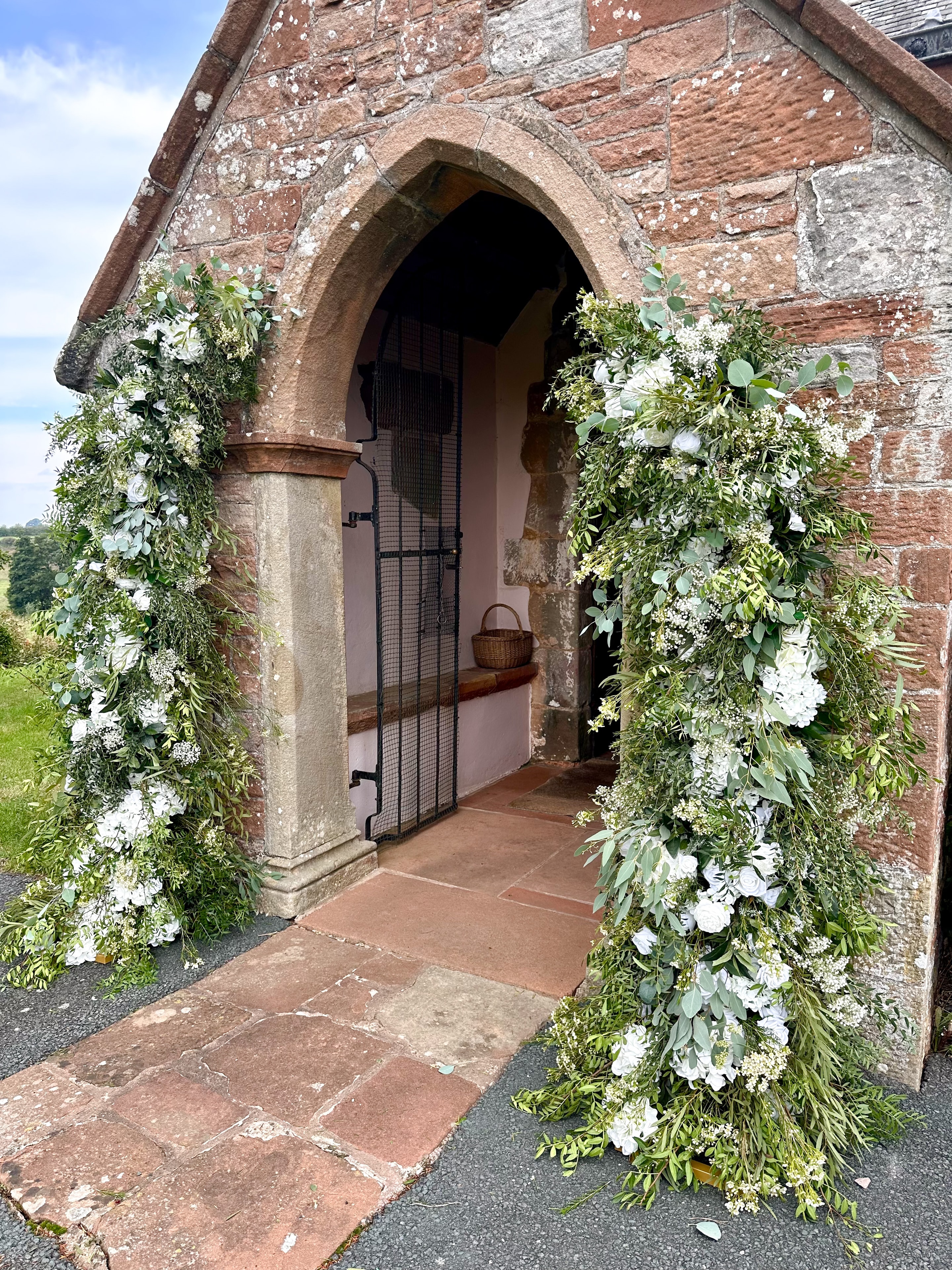 Historic chapel entrance with floral arch